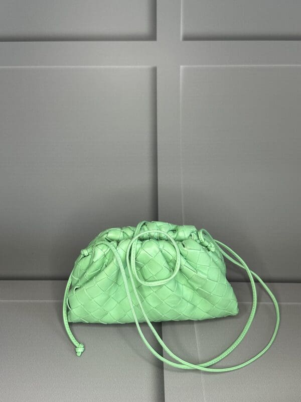 A green purse sitting on top of a counter.