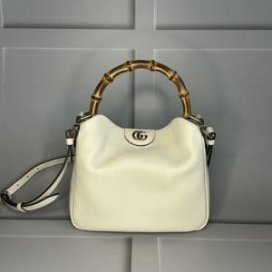 A white purse hanging on the wall