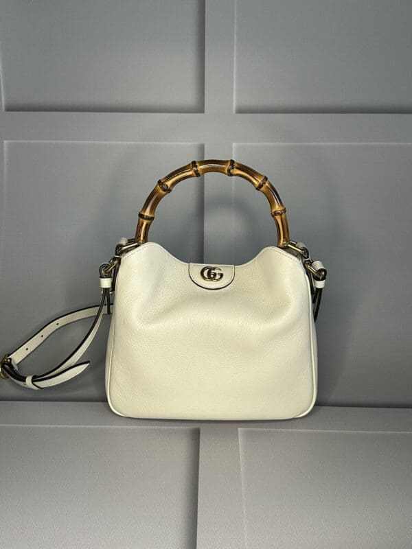 A white purse hanging on the wall