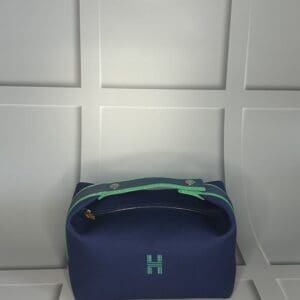 A blue bag sitting on top of a white wall.