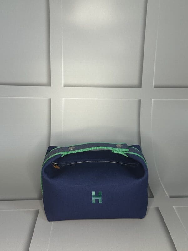 A blue bag sitting on top of a white wall.