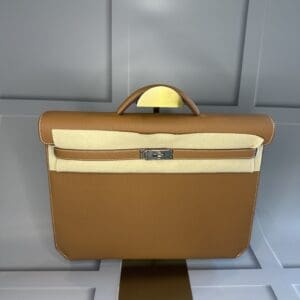 A brown briefcase sitting on top of a table.