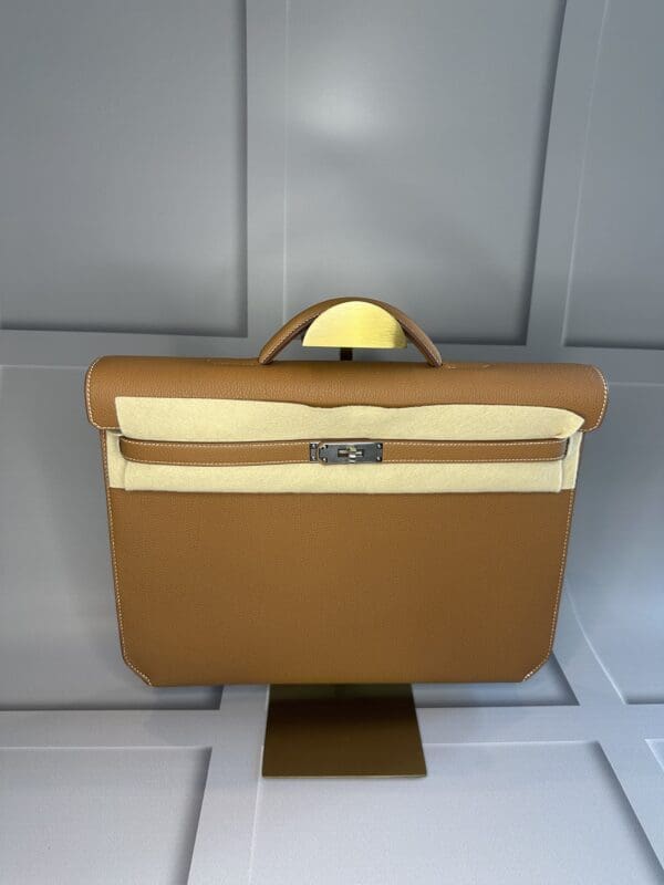 A brown briefcase sitting on top of a table.