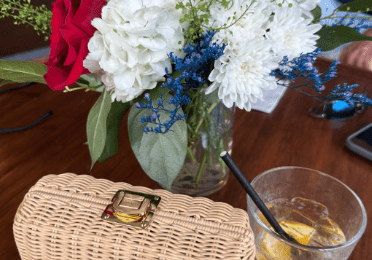 A table with flowers and a purse on it